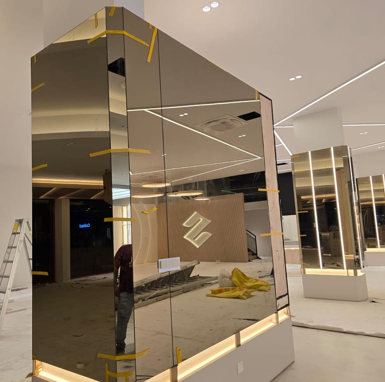 Luxury interior design construction featuring custom mirrored walls and recessed LED linear lighting.