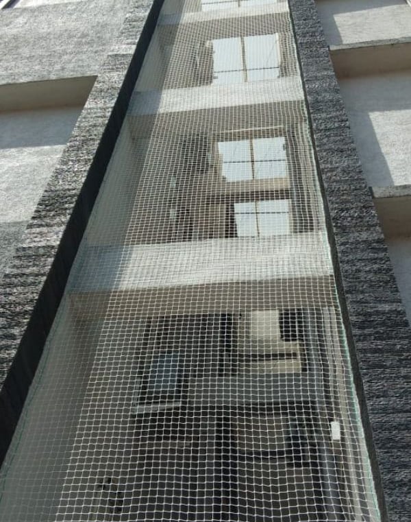 Balcony pigeon net installation protecting apartment from birds