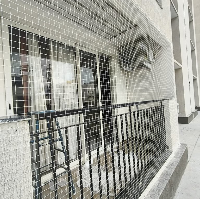 Anti pigeon net covering balcony area in residential apartment