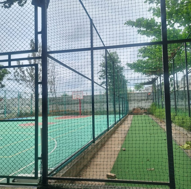 View of a vibrant football field enclosed by durable nets installed by Arjilli Safety Nets in Bengal