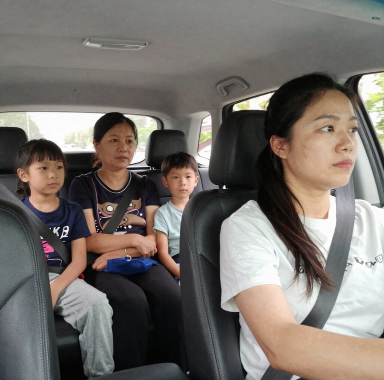 A smiling female driver opening the car door for a woman passenger in soft natural light.