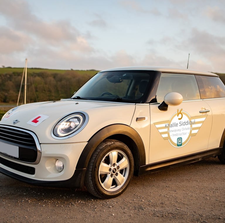 White Mini Cooper driving school car with L-plates for learner lessons in Newquay.