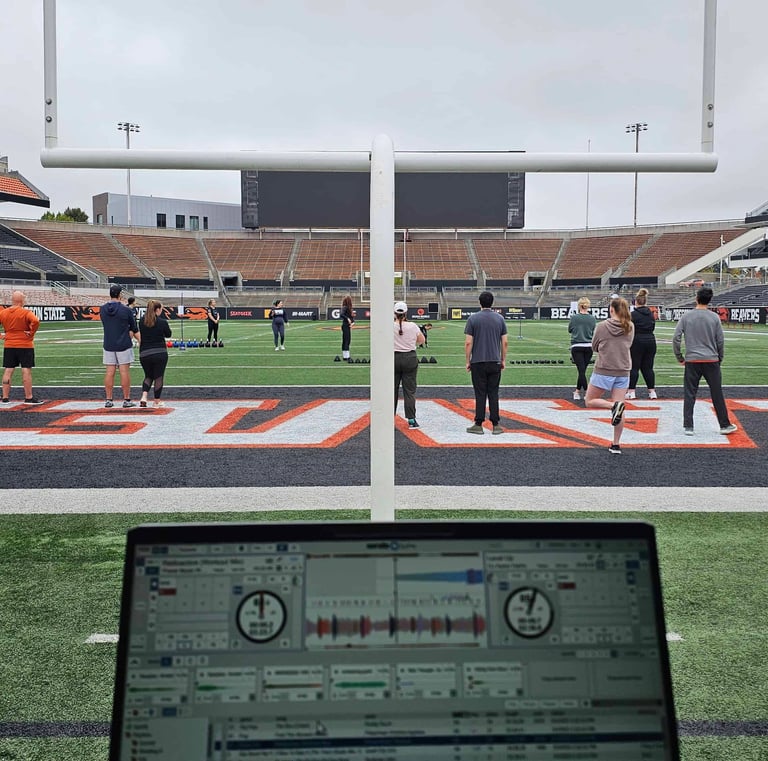 a DJ's laptop setup on the football field at Reeser Station in Oregon