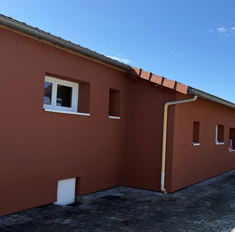 a house with a red brick wall and a white door
