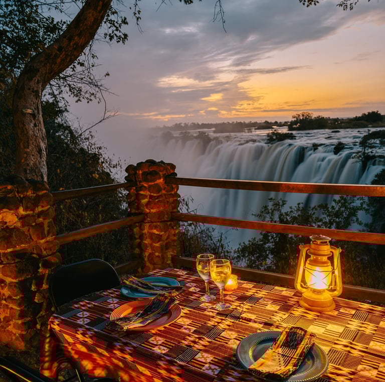 dining at sunset overlooking the Victoria Falls