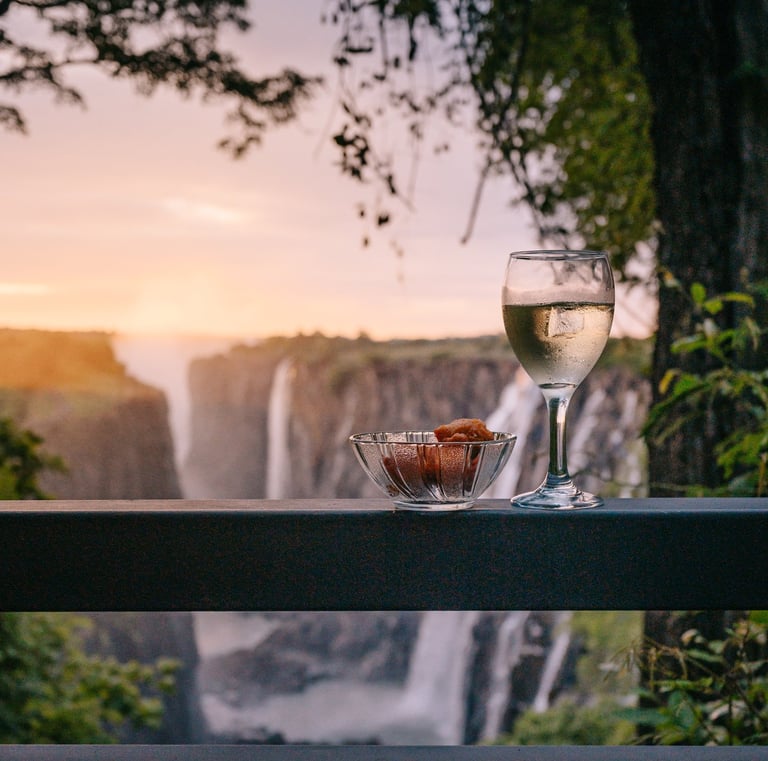 a glass of wine while enjoying the sunset at the Victoria Falls