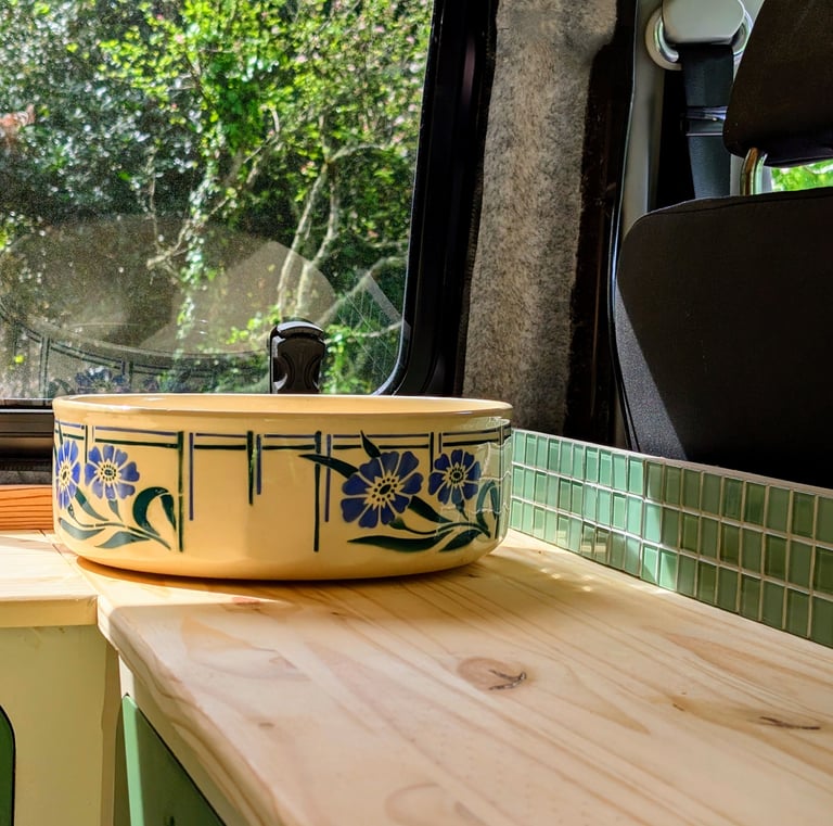 Vasque rétro en céramique fleurie sur plan de travail en bois massif, aménagement van esprit récup à