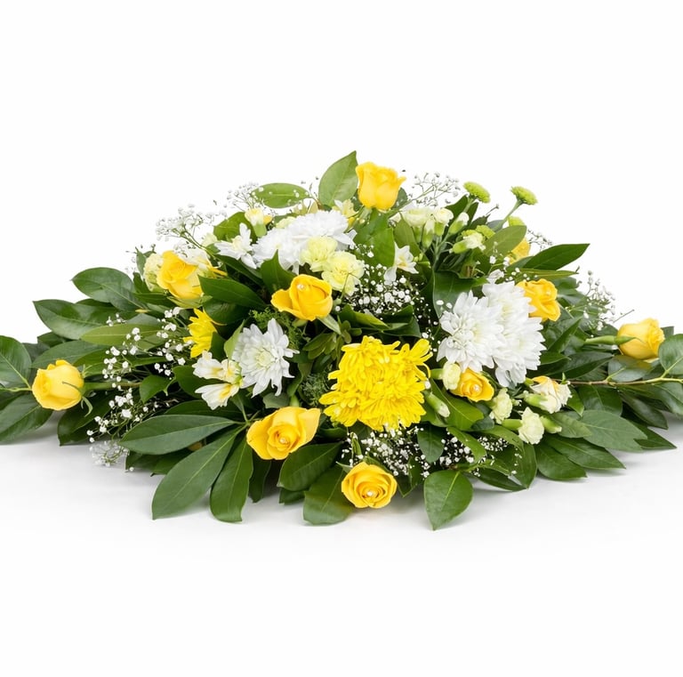 Elegant funeral casket spray featuring yellow roses and white chrysanthemums with green foliage.