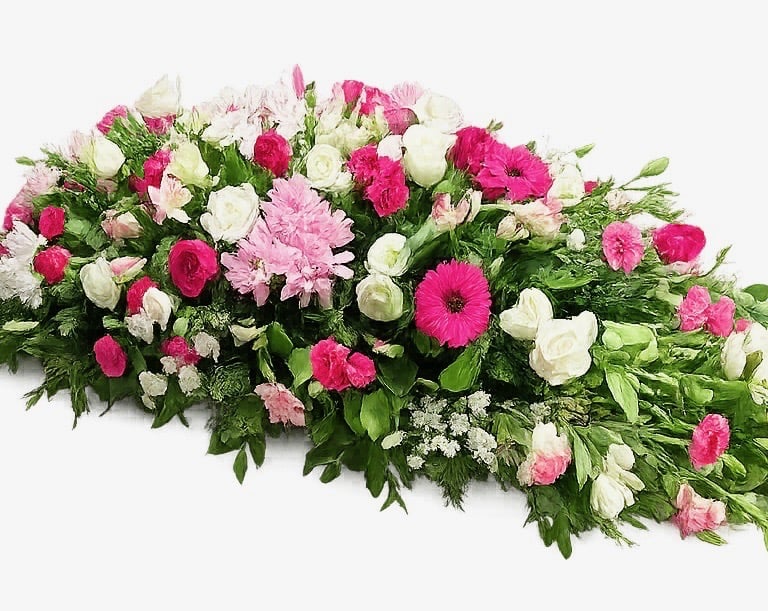 Elegant casket spray floral arrangement with pink and white roses, gerberas, and carnations for funeral services.