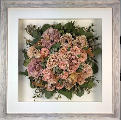 Birdseye view preserved wedding bouquet in a frame with soft peaches and pinks