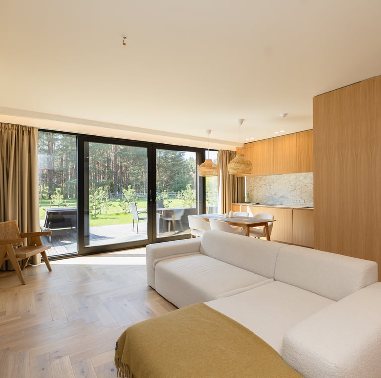Jaukus ir šiuolaikiškas „Jūra Ošia“ apartamentų interjeras su terasa ir vaizdu į pušyną.