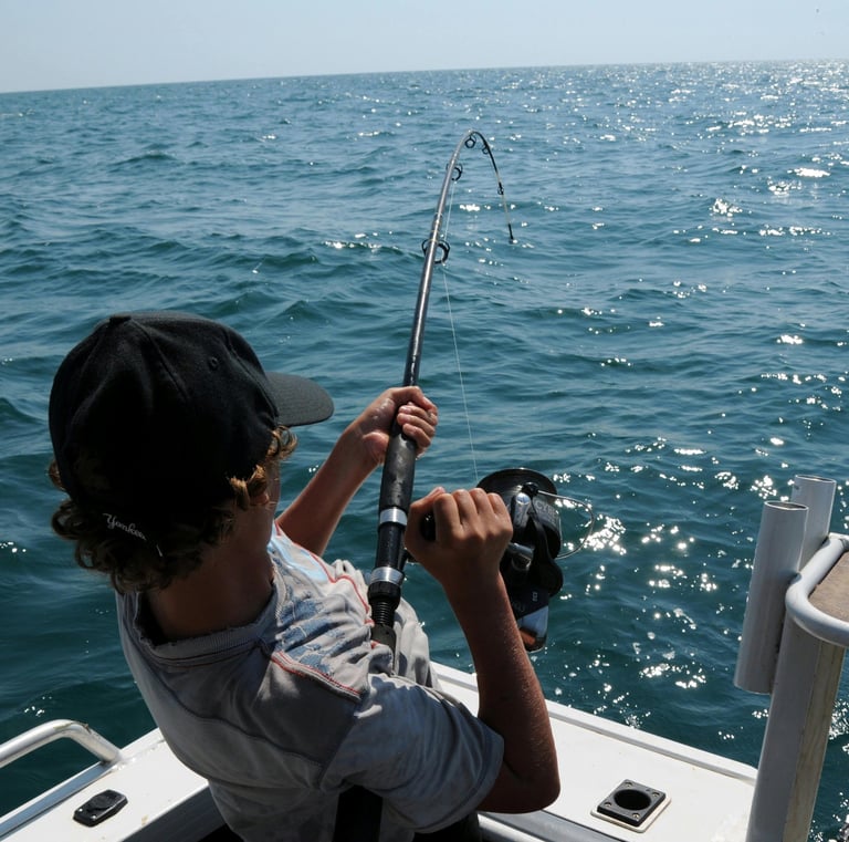 a man is fishing in the ocean with a fishing rod