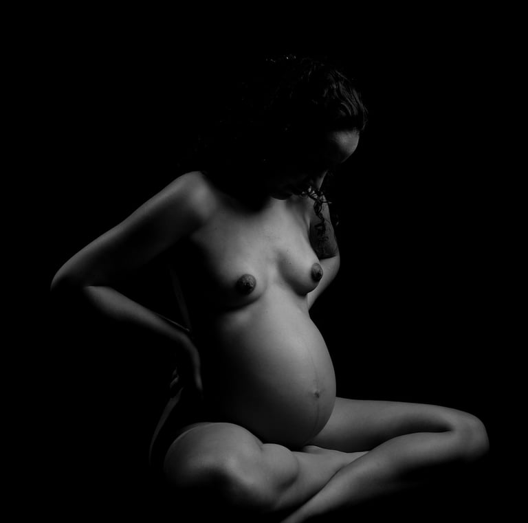 a naked pregnant woman in a mask looking down
