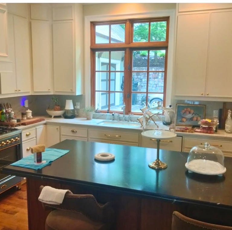 Modern kitchen with black granite island and window over sink