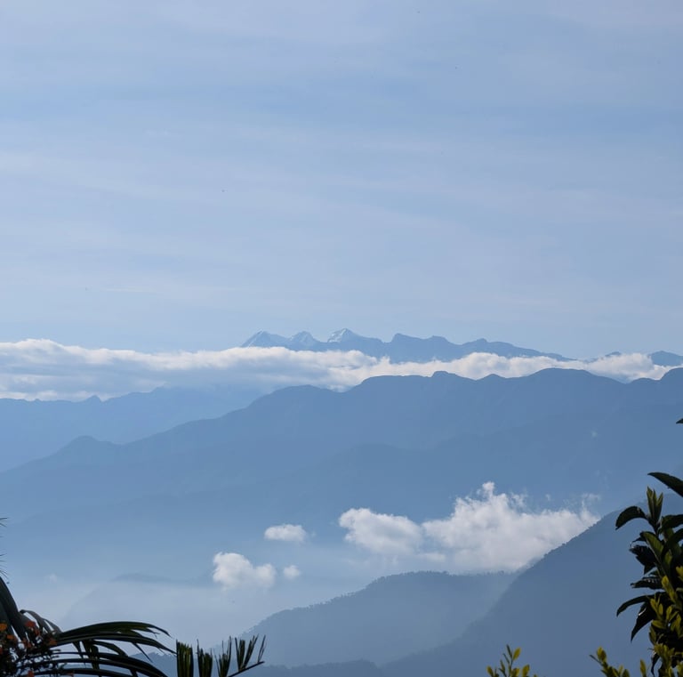 Majestic blue mountain ranges layered with thick white clouds under a clear sky. Sierra Nevada 