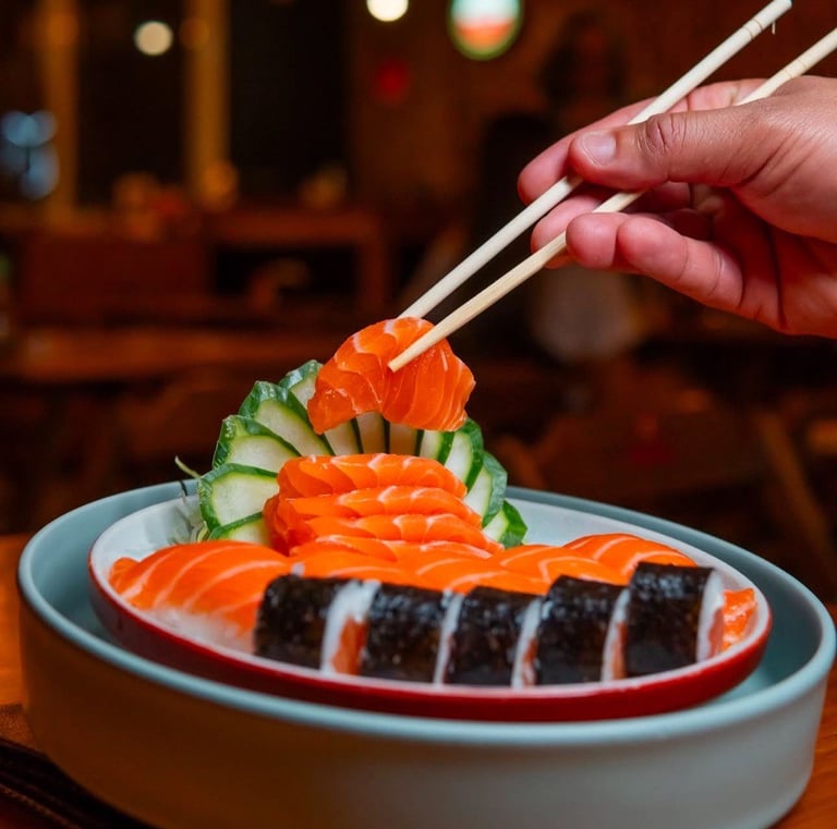 a person holding chopsticks in their hand and chopsticks in their hand