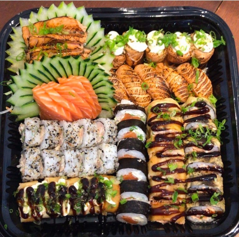 a tray of food that includes sushi and sushi