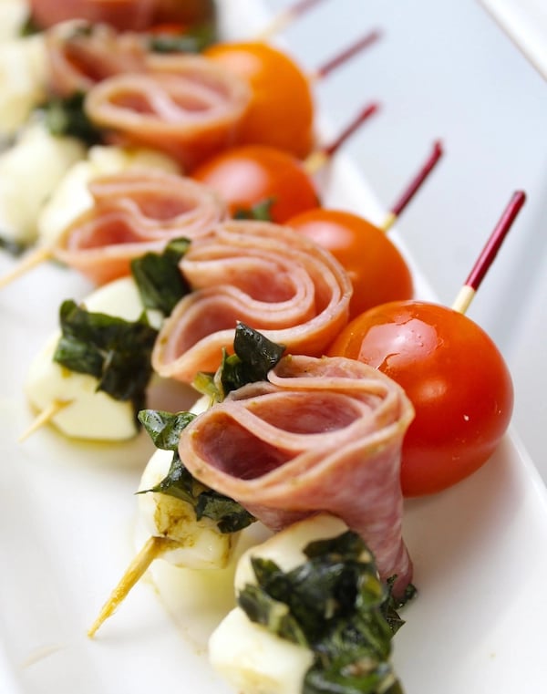 a long - terme of meat and vegetables on a white plate