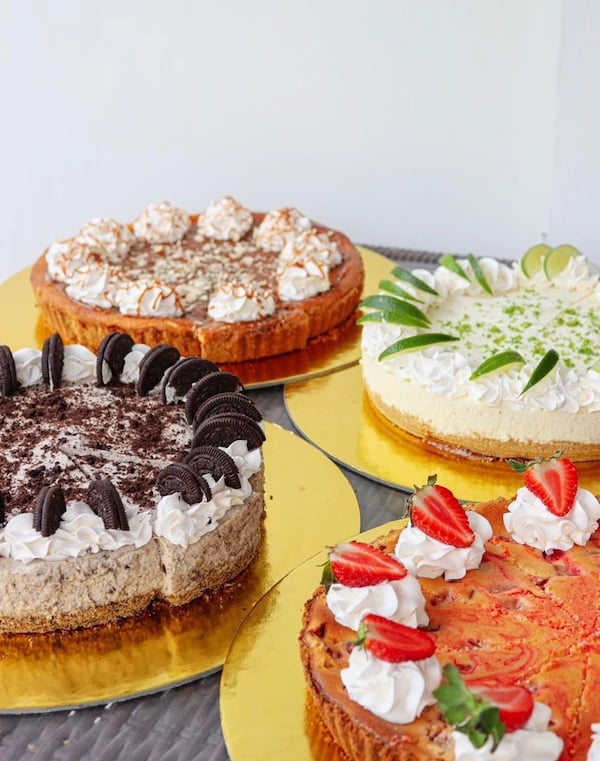 a variety of cakes on plates with strawberries