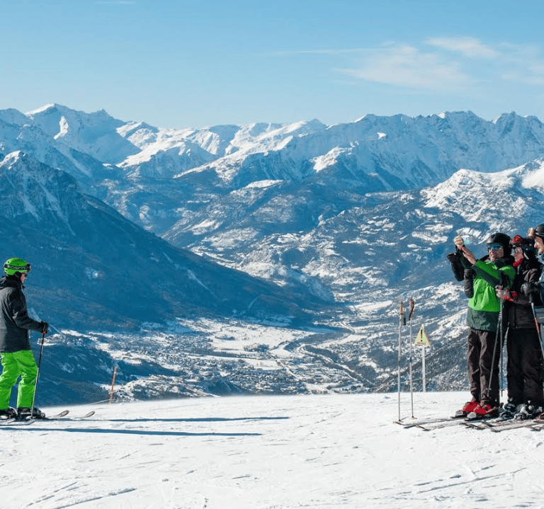 a group of people standing on a snowy mountain