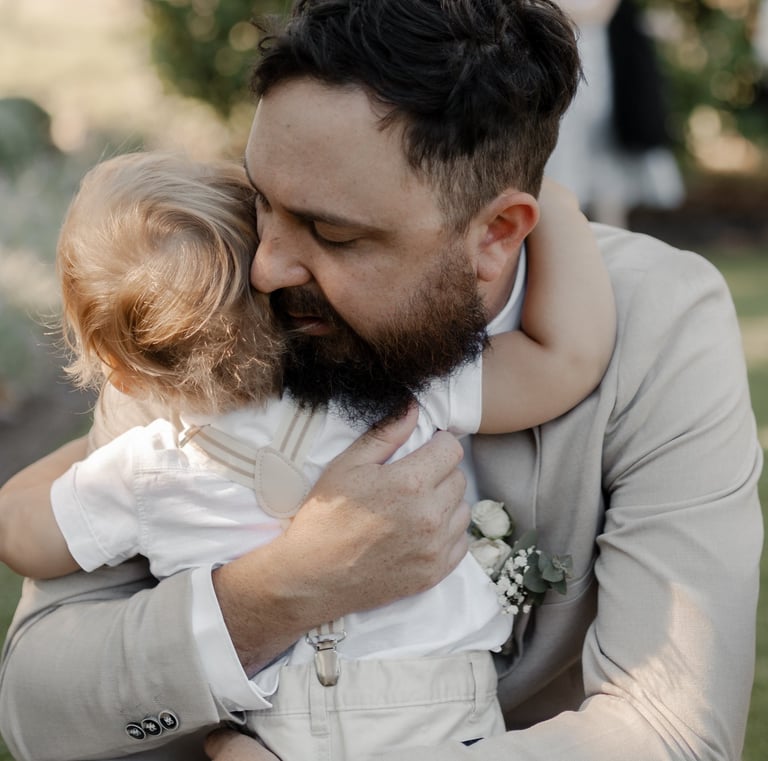 groom hugging son