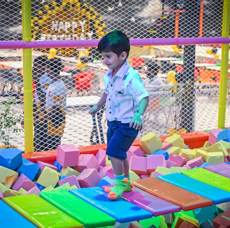 a young boy playing with blocks on a playground