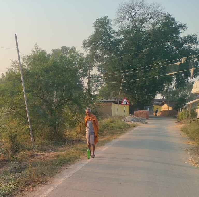 old man stand on the roadside
