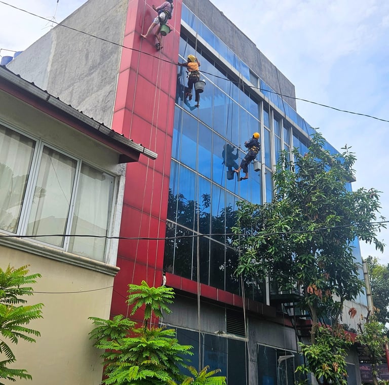 a man on a rope rope with a group of people climbing up a building