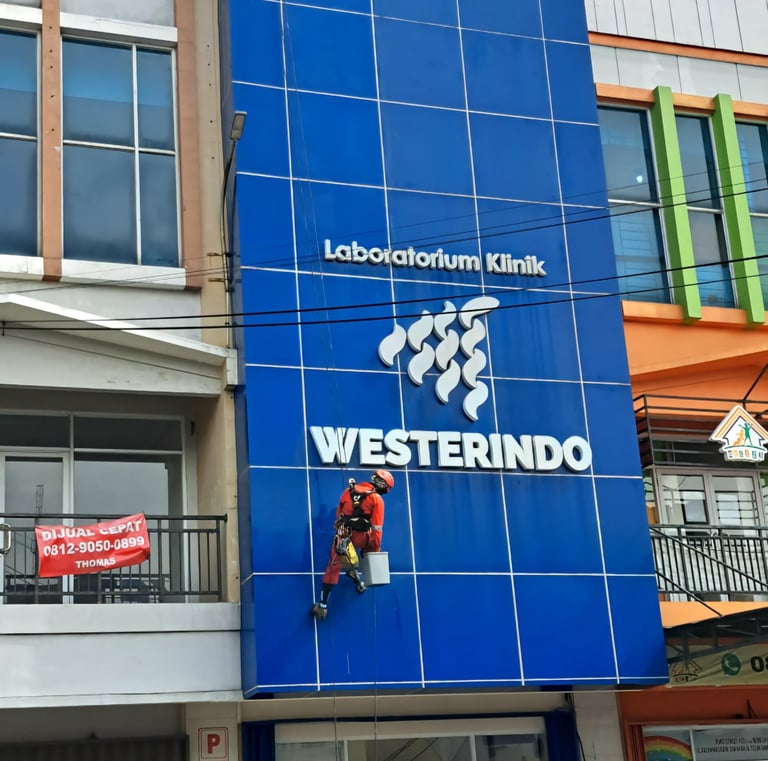 a man on a motorcycle is hanging from a building