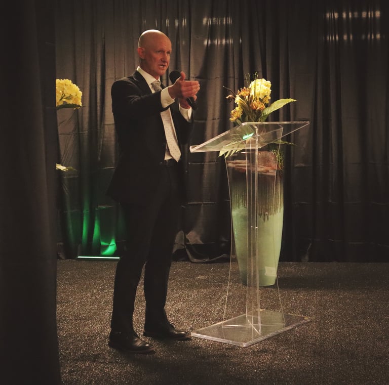Man speaking at podium for event