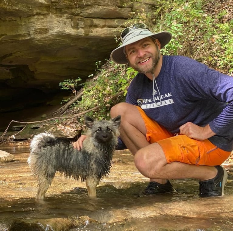 Tanner Morrill man with pomeranian keeshond mix wet dog