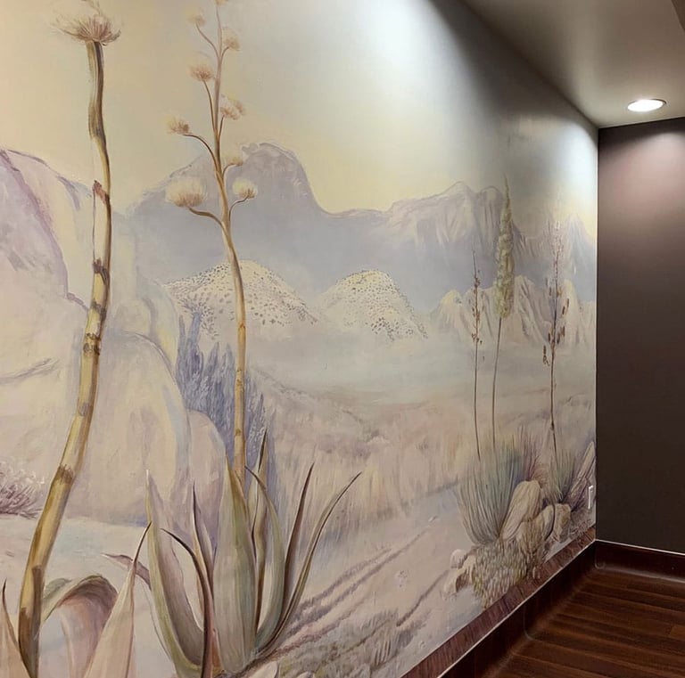 Wide angle view on a softly coloured desert dawn mural with direct lighting to illuminate mural.