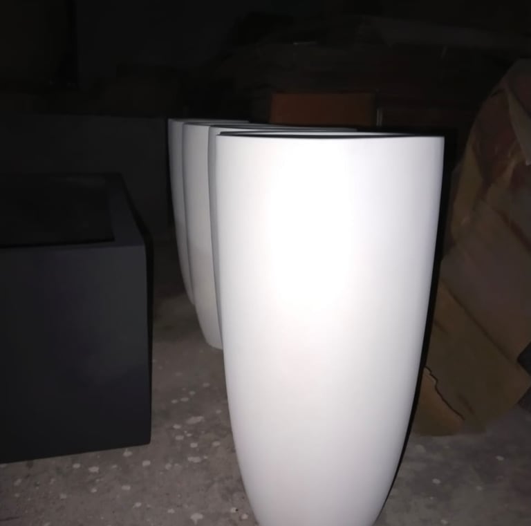 a white vase with a black and white vase