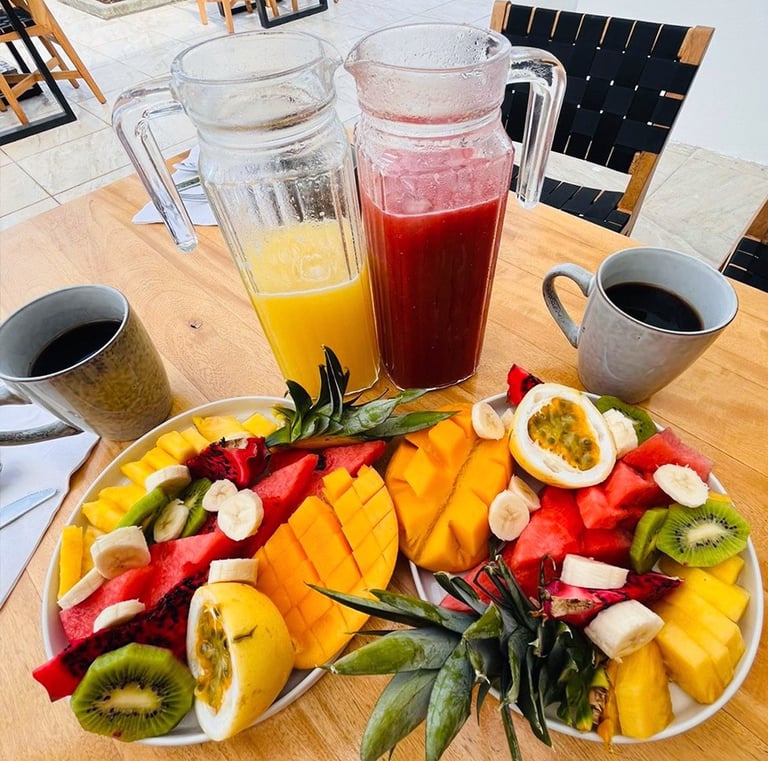 a plate of fruit and juice on a table