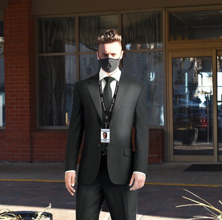 A male concierge standing at the front door