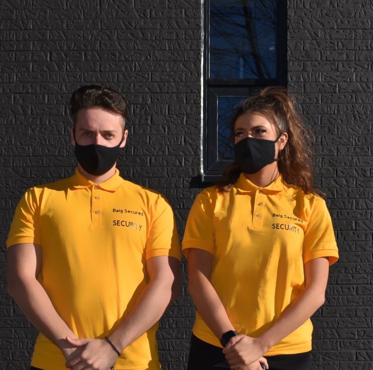 Two Security Guard Standing beside a building