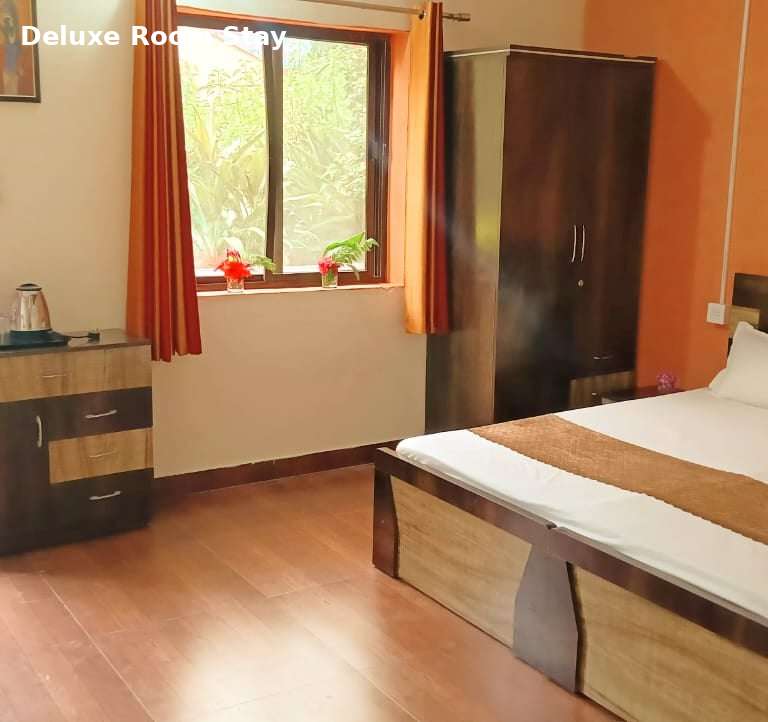Deluxe room at Jungle Lore Resort with comfortable bed and modern interior