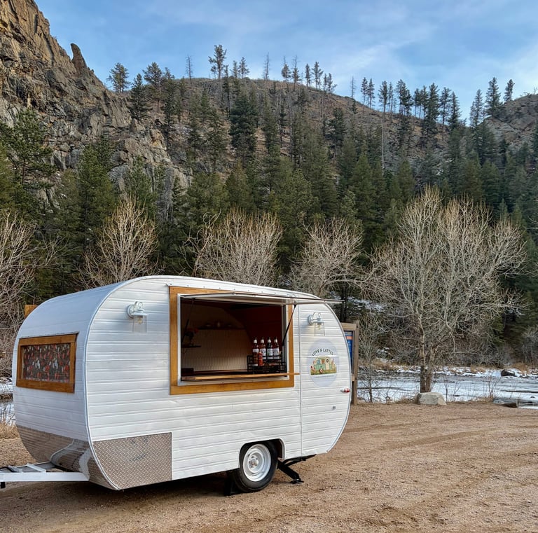 Image 1 → "Love & Lattes vintage coffee trailer exterior at an outdoor event" 