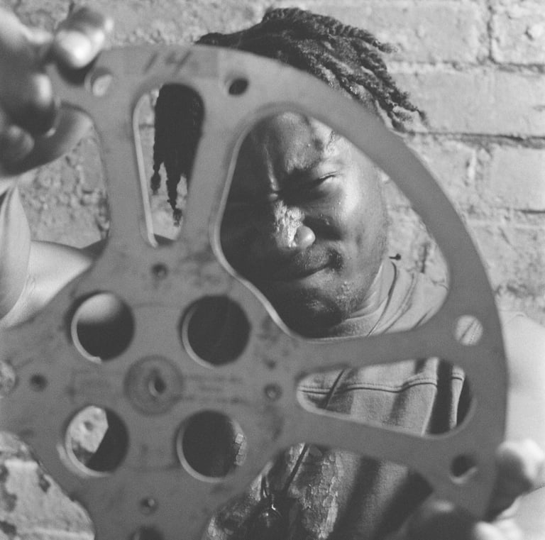 a man holding a film reel