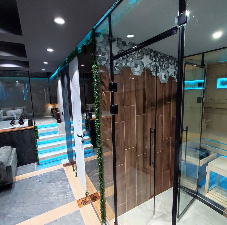 a bathroom with a glass shower and a couch