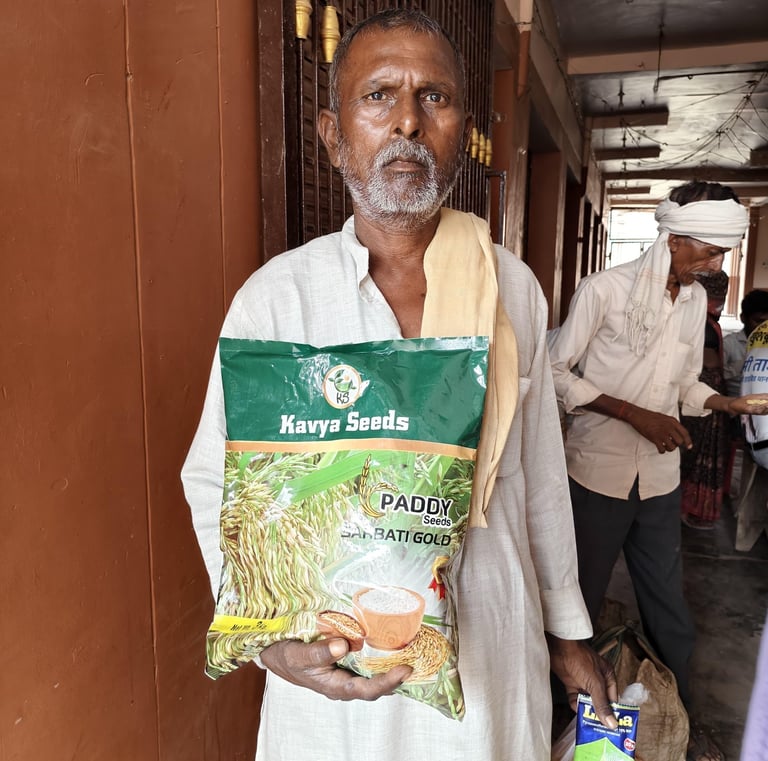 An Indian farmer holding a bag of Kavya Seeds Sarbati Gold paddy rice seeds for agriculture.