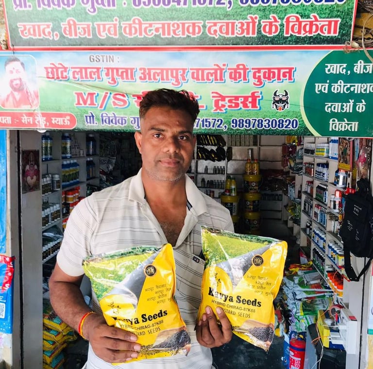 A merchant displays Kavya mustard seeds in front of his agricultural fertilizer and pesticide store.