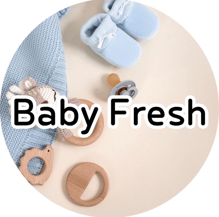 Baby booties, knit blanket, and wooden teether with text reading "Baby Fresh." Soft nursery aesthetic.