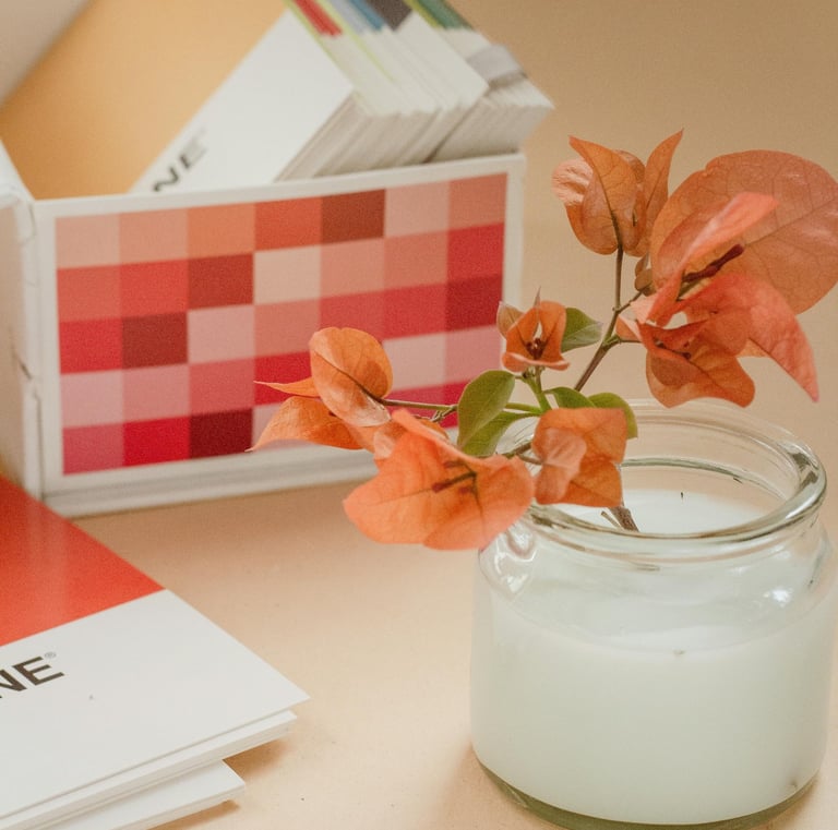 Flowers in a jar near Pantone color swatches box