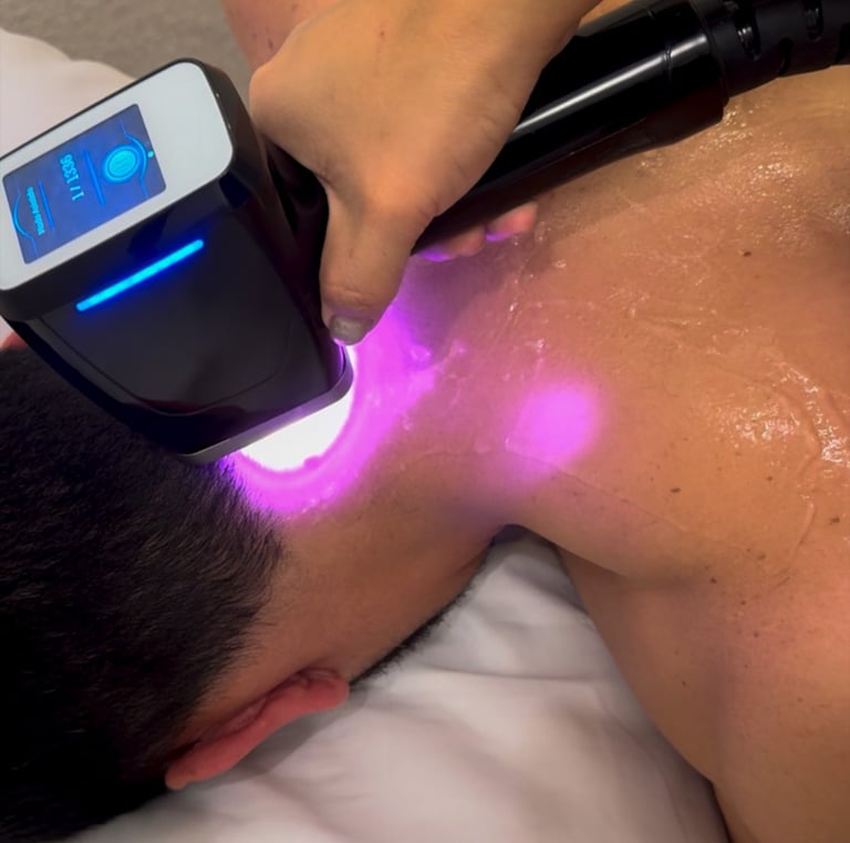 Professional laser hair removal treatment on a man's upper back and neck at a skin care clinic.
