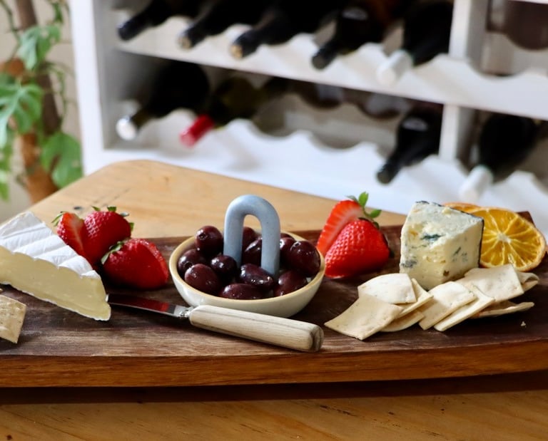 cheese platter with dehydrated fruit on it for garnish