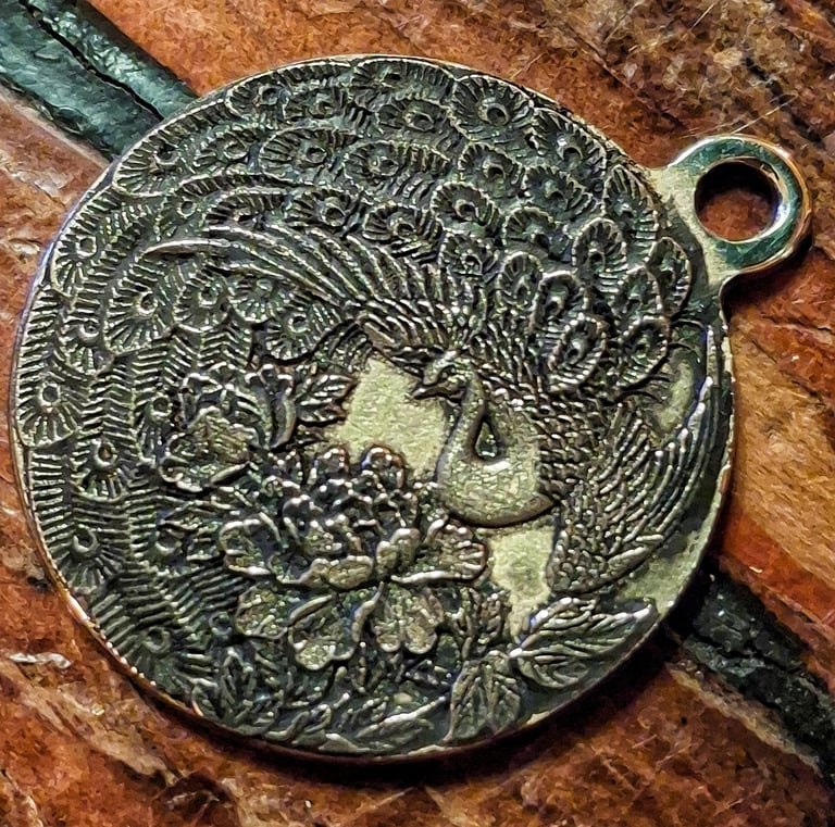 3 dimensional "3d relief" engraving of a peacock in brass