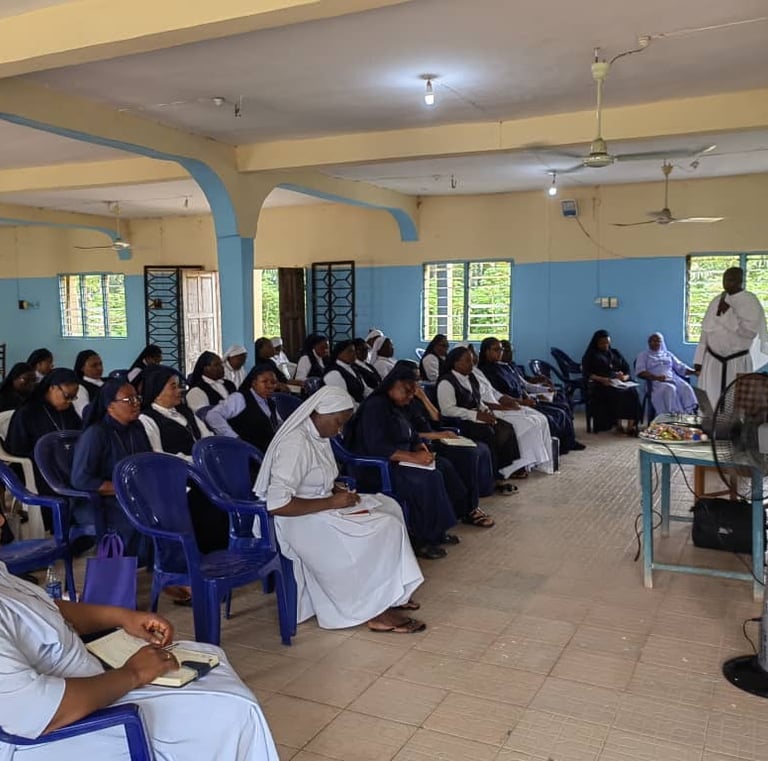 A group of Catholic nuns in habits attend a religious seminar or educational workshop in a classroom.