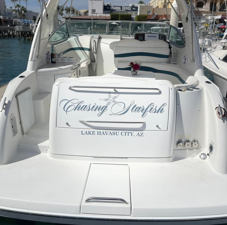 White motorboat named Chasing Starfish docked at a Lake Havasu City marina in Arizona.