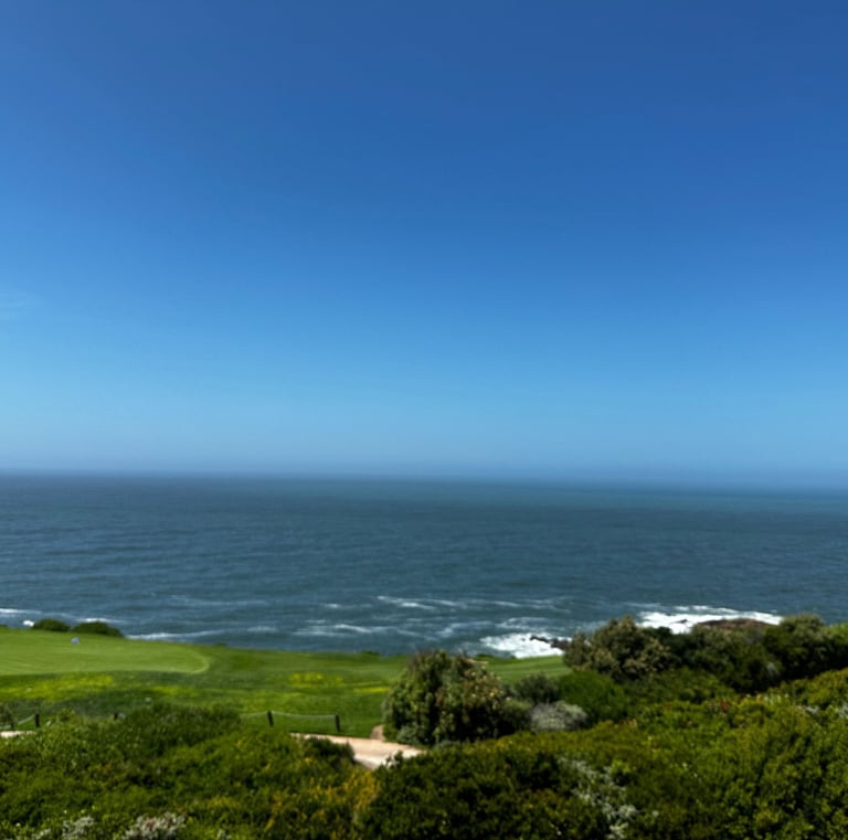 a golf course with a view of the ocean